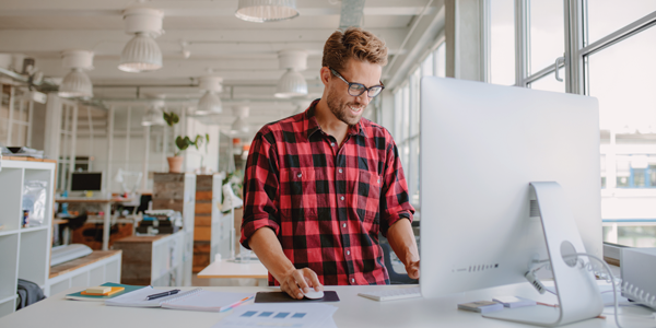 Man using a sit stand desk